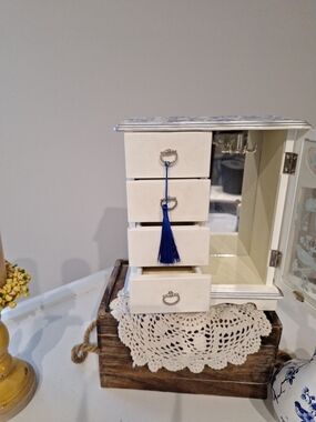 White Jewelry Organizer Armoire with Blue Tassel Accent